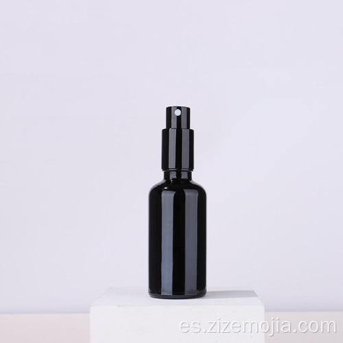 Botella de espray de cristal negra vacía con bomba